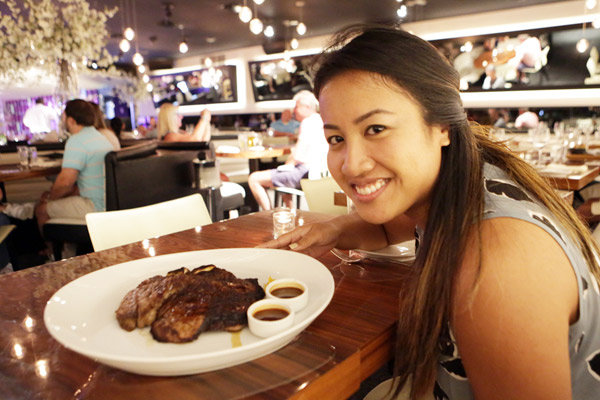 Maureen Mariano with a porterhouse steak at STK Orlando at Disney Springs